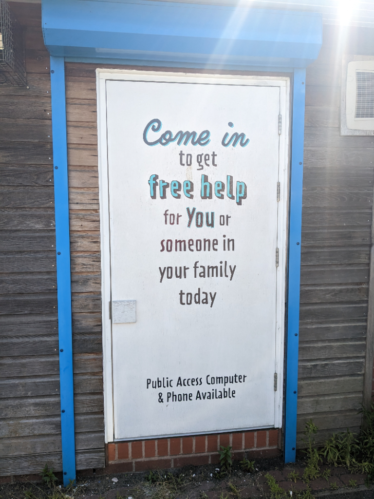 A sign outside Woodside Family Hub in Willenhall says you can come in for free help for you and your family today.