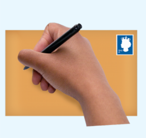 A hand holding a pen writing on a brown envelope with a stamp in the corner