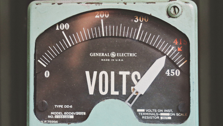 Volts shown on a gauge. Image by Thomas Kelley on Unsplash.