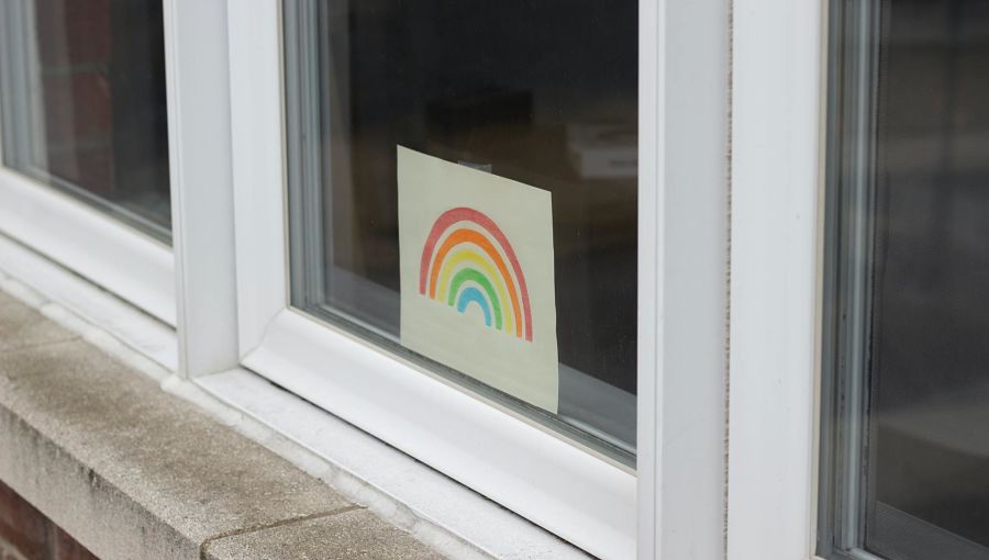 A hand drawn rainbow in a window