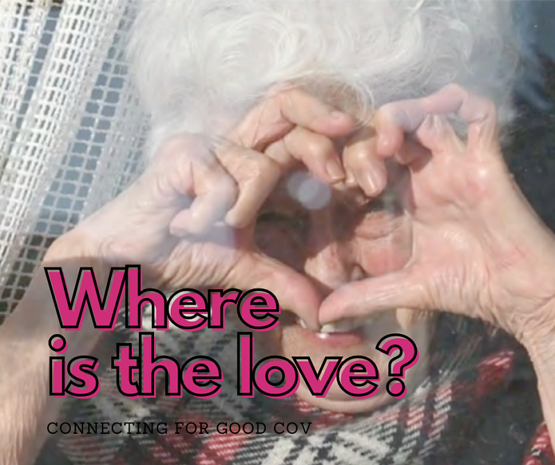 Older woman at window making heart shape with her hands